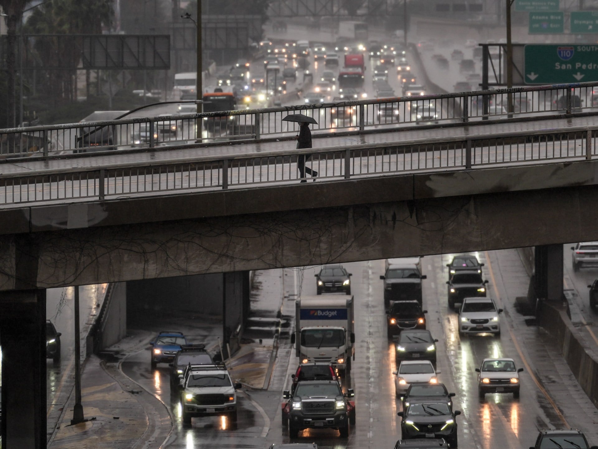 California Wildfire Rages as Los Angeles Braces for Flooding